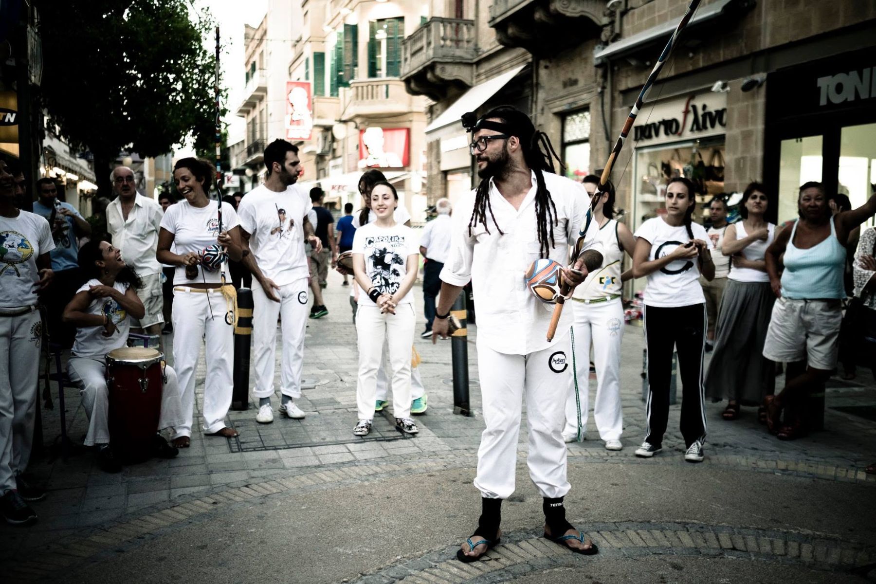 Mestre Casquinha with a berimbau leading an Apêiara street roda on Ledras Street, Nicosia