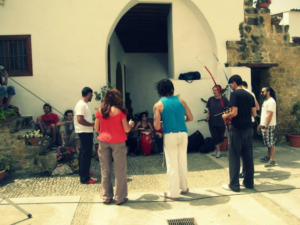 Capoeiristas with berimbaus and an atabaque gathering in a courtyard in Old Nicosia for the first street performance in 2010